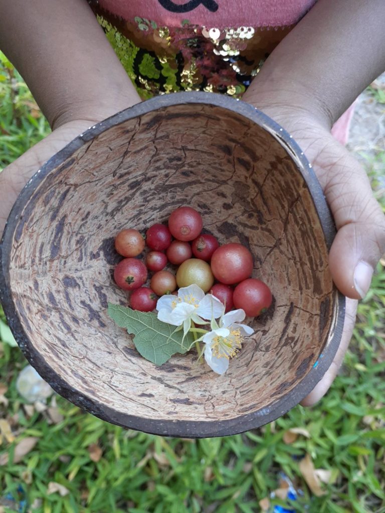 kids with a jeymu bowl made out of coconut shell